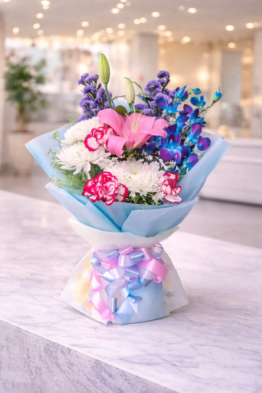 A Floral Bouquet Featuring A Mix of Flowers Including Lilies, Carnations, Orchids, And Chrysanthemums.