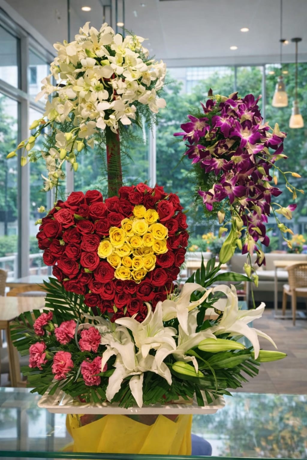 Multi-Tiered Exotic Flower Display: Red & Yellow Rose Heart, Purple Orchids, and White Lilies Arrangment