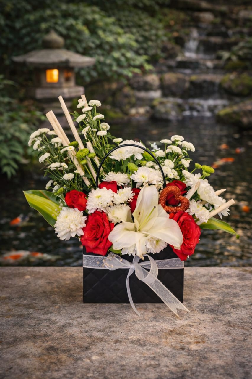 A Floral Arrangement Presented In A Black Gift Box.